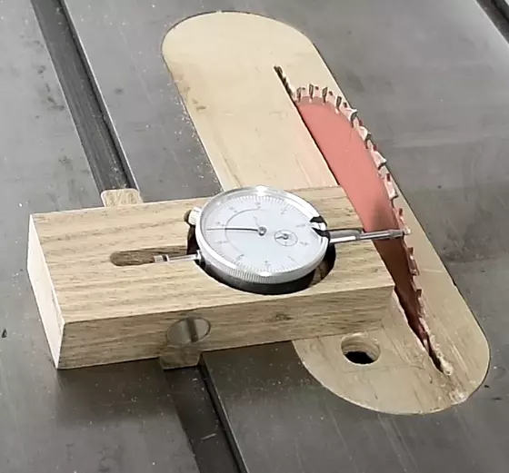 How do you use a dial indicator on a table saw